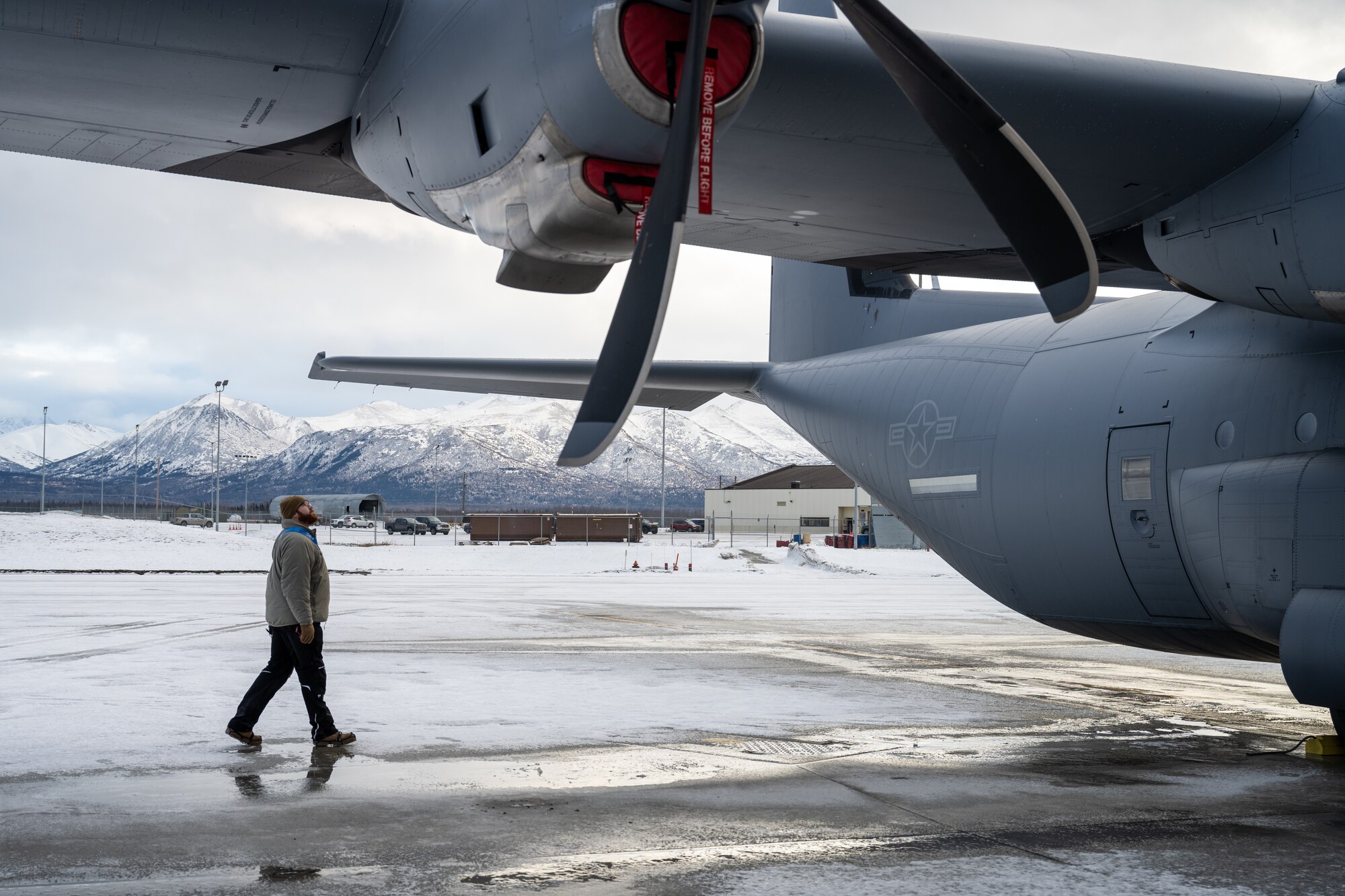 U.S. Air Force Tech. Sgt. Tyler Nelson, 317th Aircraft Maintenance Squadron flying crew chief and Lethal Expeditionary Airman Development course graduate, evaluates a C-130J Super Hercules during Joint Pacific Multinational Readiness Center 25-02 exercise at Joint Base Elmendorf-Richardson, Alaska, Jan. 22, 2025. Nelson’s 18-Airmen team maintained two C-130J Super Hercules in extreme cold weather conditions, enabling the 40th Airlift Squadron to deliver fully mission-capable aircraft and integrate with nearly 10,000 Department of Defense service members during JPMRC 25-02. (U.S. Air Force photo by Airman 1st Class Jade M. Caldwell)