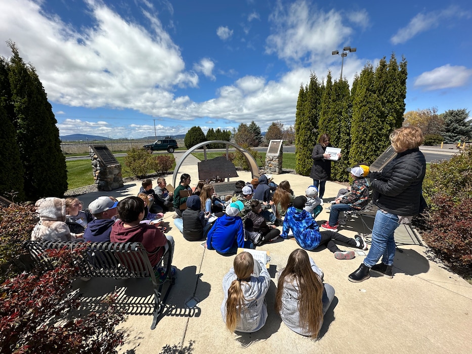 Student gather in a circle to listen to the instructor