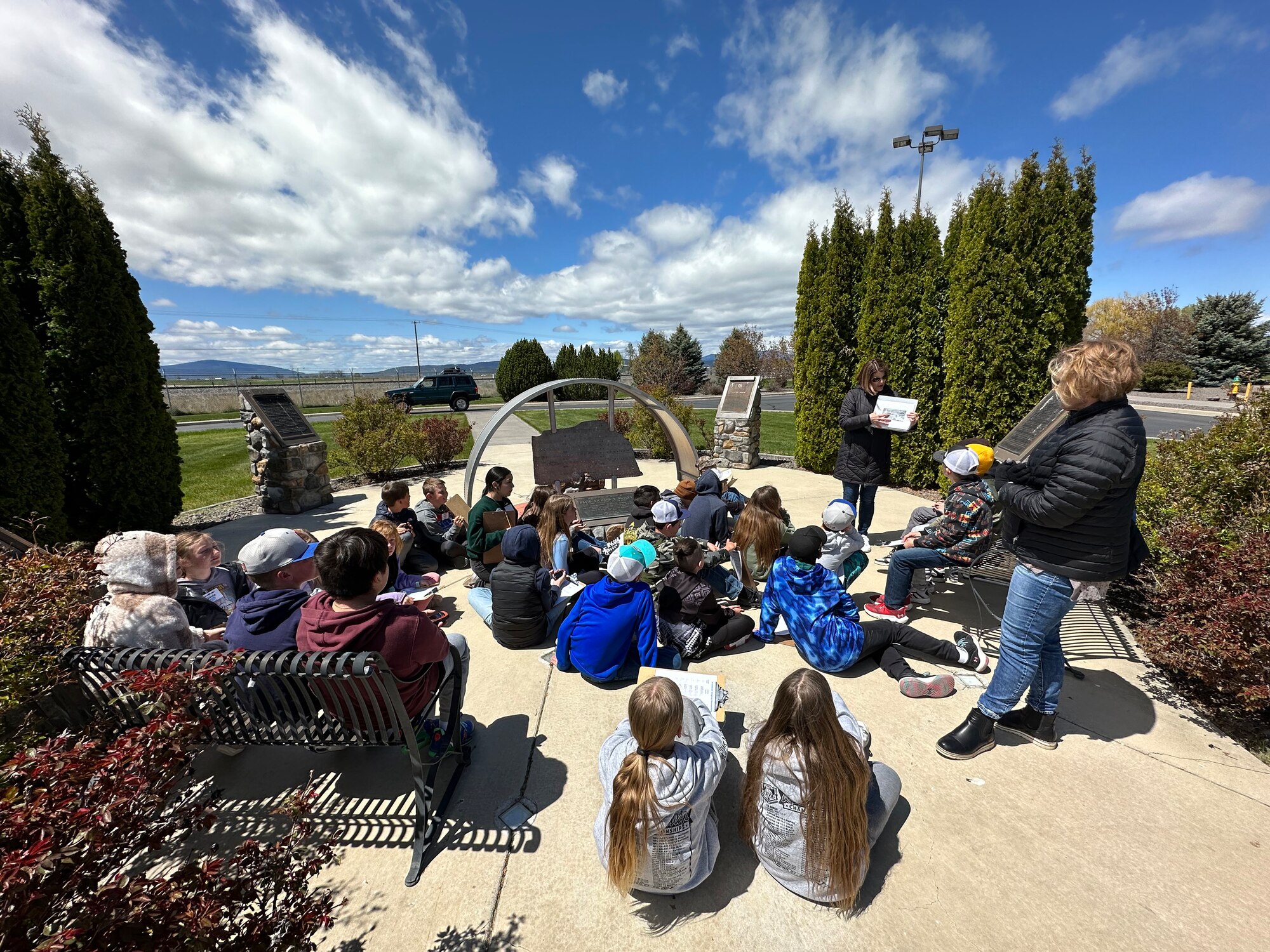 Student gather in a circle to listen to the instructor
