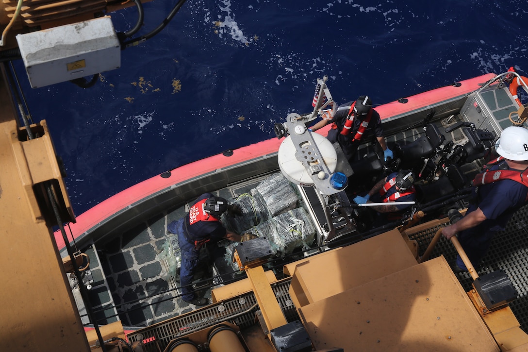 A USCGC Valiant (WMEC 621) law enforcement team aboard a small boat gets lifted aboard the cutter after a drug interdiction approximately 50 miles northeast of the Dominican Republic, Feb. 17, 2025. U.S. Customs and Border Protection Air and Marine Operations aircrew detected the suspicious vessel and vectored in the Valiant crew who apprehended five suspected smugglers and seized approximately 1,280 pounds of cocaine. (U.S. Coast Guard photo by Seaman Reese Fishbaugh)