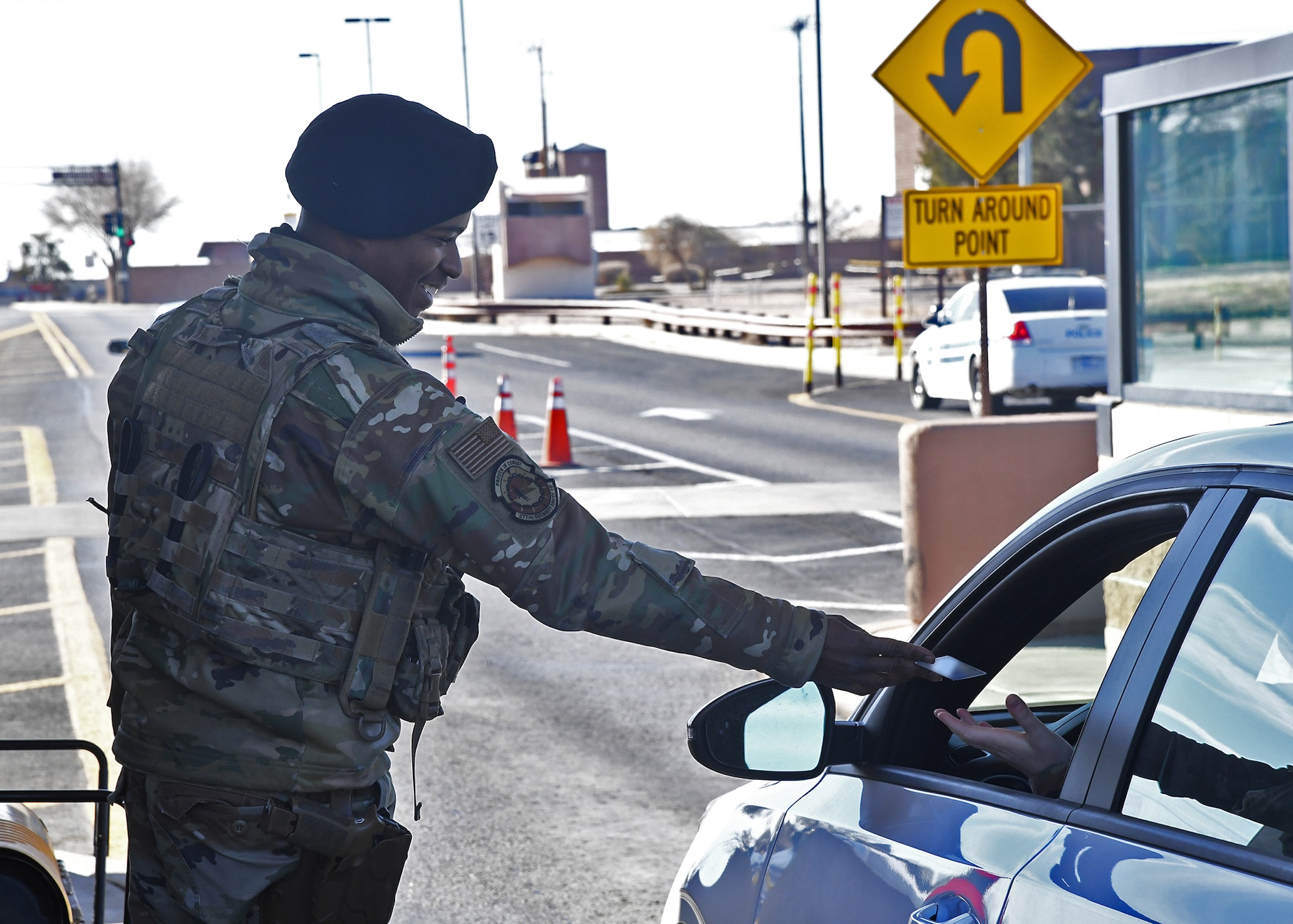 Airman 1st Class Derek Brown, 377th Security Forces Squadron, checks identifications at the gate to Kirtland Air Force Base, New Mexico Feb. 2.