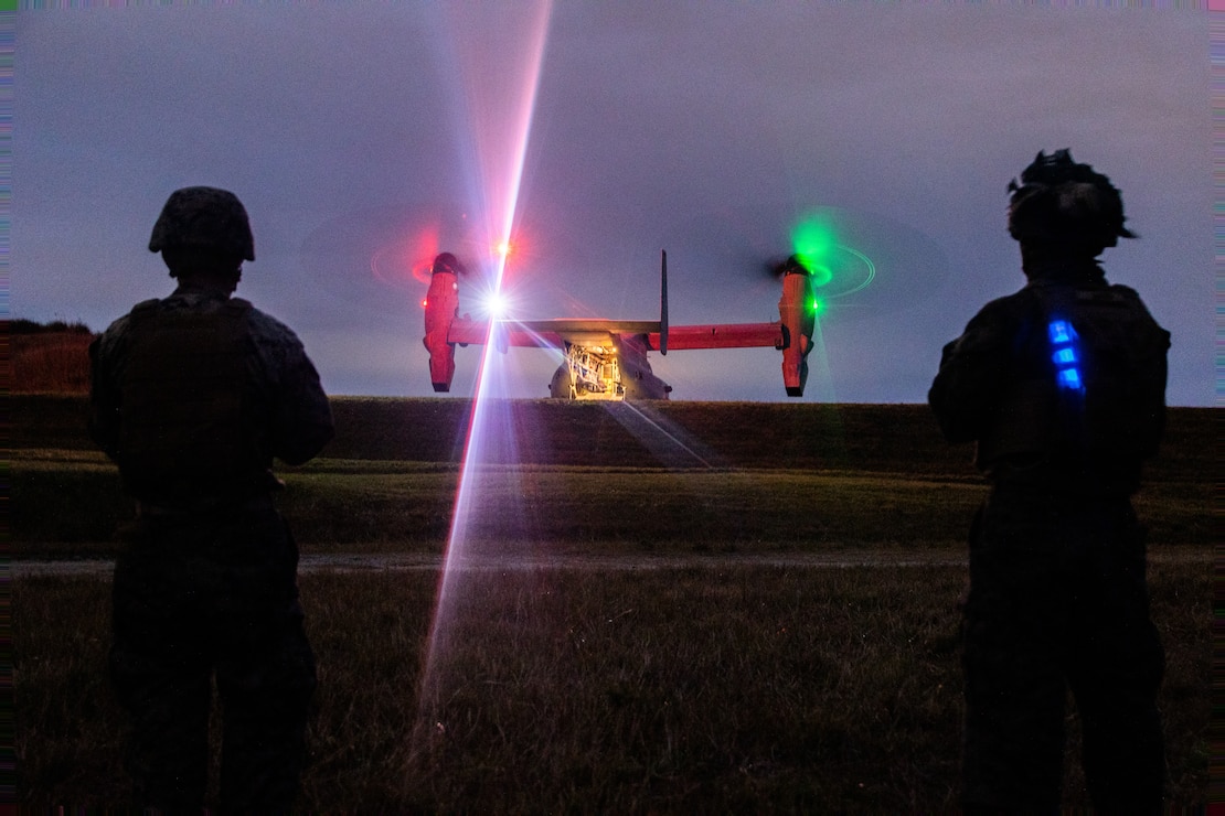 U.S. Marines with Combat Logistic Company Bravo, Combat Logistics Battalion 31, 31st Marine Expeditionary Unit, observe a U.S. Marine Corps MV-22 Osprey assigned to Marine Medium Tiltrotor Squadron (VMM) 262 (Rein.), 31st MEU, during an external lift exercise in support of Iron Fist 25, at Camp Hansen, Okinawa, Japan, Feb. 20, 2025.