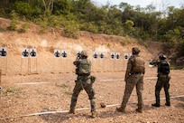 U.S. Marine Corps Sgt. Dody Martinell, a light armored reconnaissance Marine with 1st Light Armored Reconnaissance Battalion, 1st Marine Division, coaches a Republic of Korea Marine, left, and a Royal Thai Marine, right, during a live-fire short bay range at Thai Reconnaissance Battalion, Sattahip, Thailand, Feb. 28, 2025,