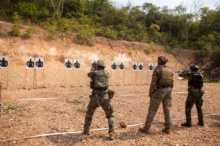 U.S. Marine Corps Sgt. Dody Martinell, a light armored reconnaissance Marine with 1st Light Armored Reconnaissance Battalion, 1st Marine Division, coaches a Republic of Korea Marine, left, and a Royal Thai Marine, right, during a live-fire short bay range at Thai Reconnaissance Battalion, Sattahip, Thailand, Feb. 28, 2025,
