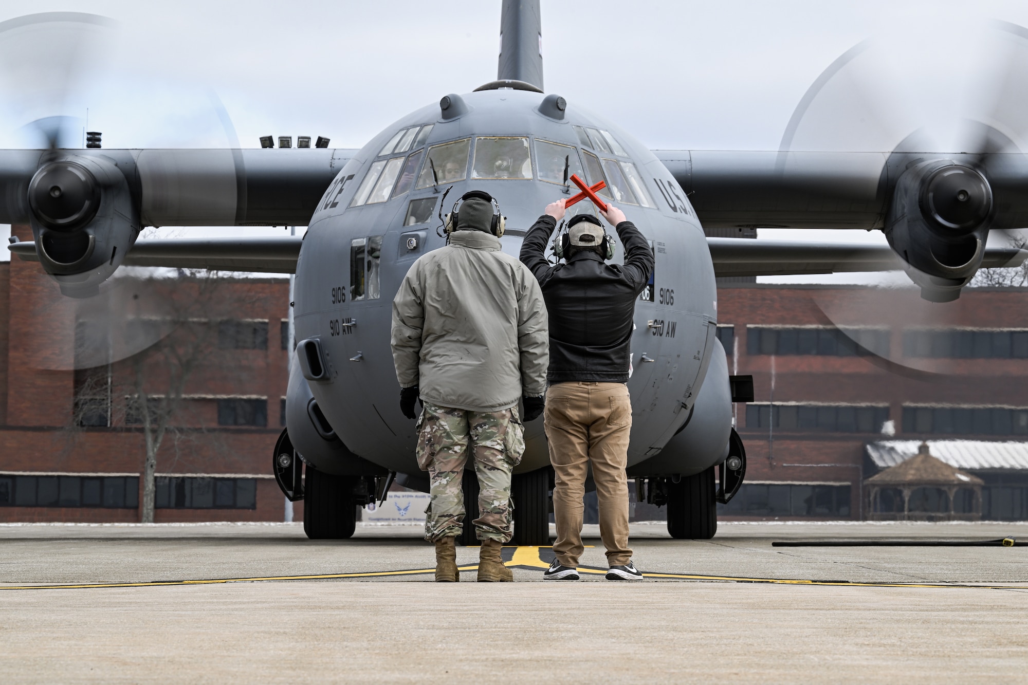 The son of Col. Michael Maloney, 910th Airlift Wing commander, marshals in his father after landing from his “fini-flight” at Youngstown Air Reserve Station, Ohio, March 2, 2025.