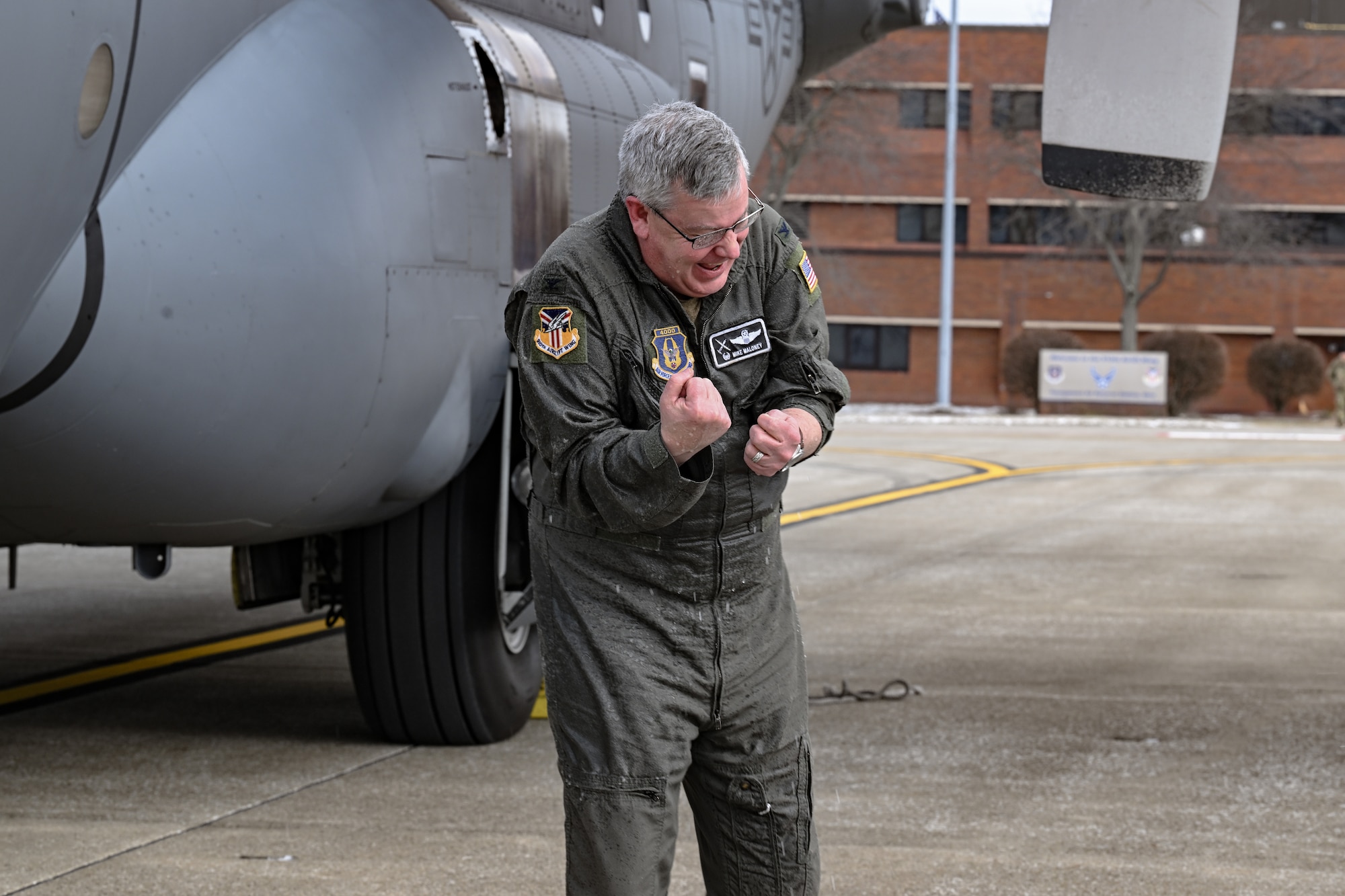 Col. Michael Maloney, 910th Airlift Wing commander, gets hosed down after landing from his “fini-flight” at Youngstown Air Reserve Station, Ohio, March 2, 2025.