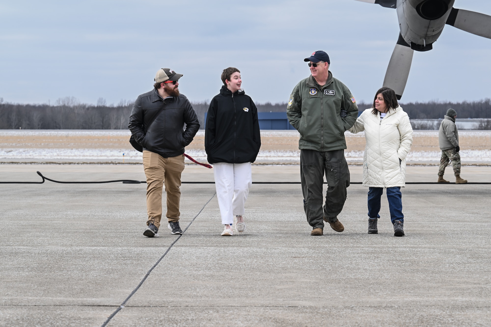Col. Michael Maloney, 910th Airlift Wing commander, walks with his family after landing from his “fini-flight” at Youngstown Air Reserve Station, Ohio, March 2, 2025.