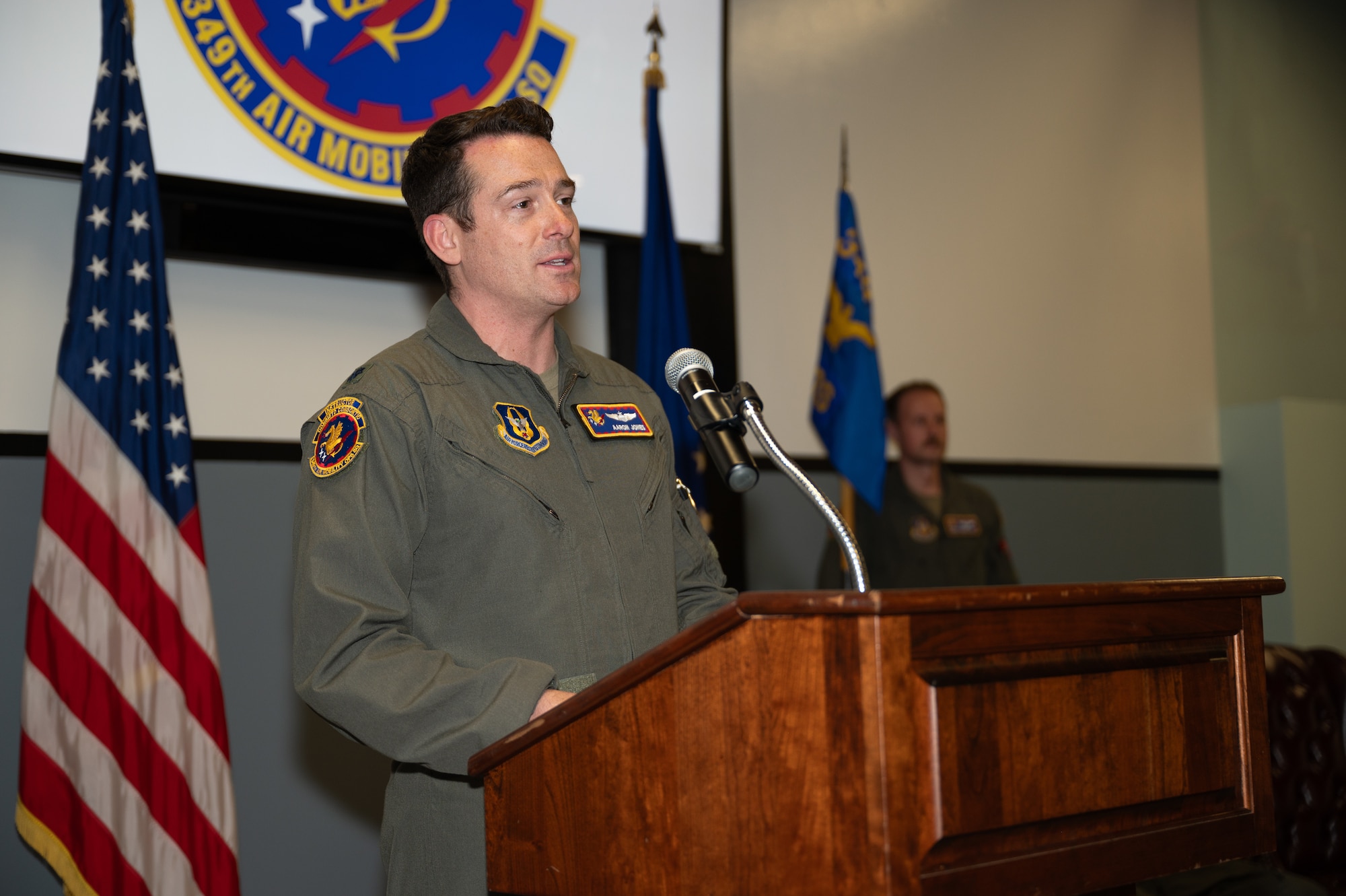 Lt Col Aaron Jones speak at the podium during the ceremony.