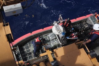 A USCGC Valiant (WMEC 621) law enforcement team aboard a small boat gets lifted aboard the cutter after a drug interdiction approximately 50 miles northeast of the Dominican Republic, Feb. 17, 2025. U.S. Customs and Border Protection Air and Marine Operations aircrew detected the suspicious vessel and vectored in the Valiant crew who apprehended five suspected smugglers and seized approximately 1,280 pounds of cocaine. (U.S. Coast Guard photo by Seaman Reese Fishbaugh)