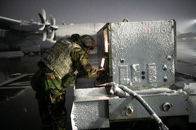 YOKOTA AIR BASE, TOKYO, Japan (March 4, 2025) — U.S. Air Force Senior Airman Michael Ricketts, 374th Aircraft Maintenance Squadron avionics technician, conducts maintenance on ground support equipment during inclement weather for exercise Beverly Morning 25-2 at Yokota Air Base, Japan, March 4, 2025. BM 25-2 is an annual exercise designed to sharpen Mission Ready Airmen and fortify base readiness. Through routine training, personnel at Yokota Air Base remain postured to rapidly respond to any potential real-world crises and maintain its status as the premiere hub for power projection in the Indo-Pacific theater. (U.S. Air Force photo by Airman 1st Class Cayla Hunt)