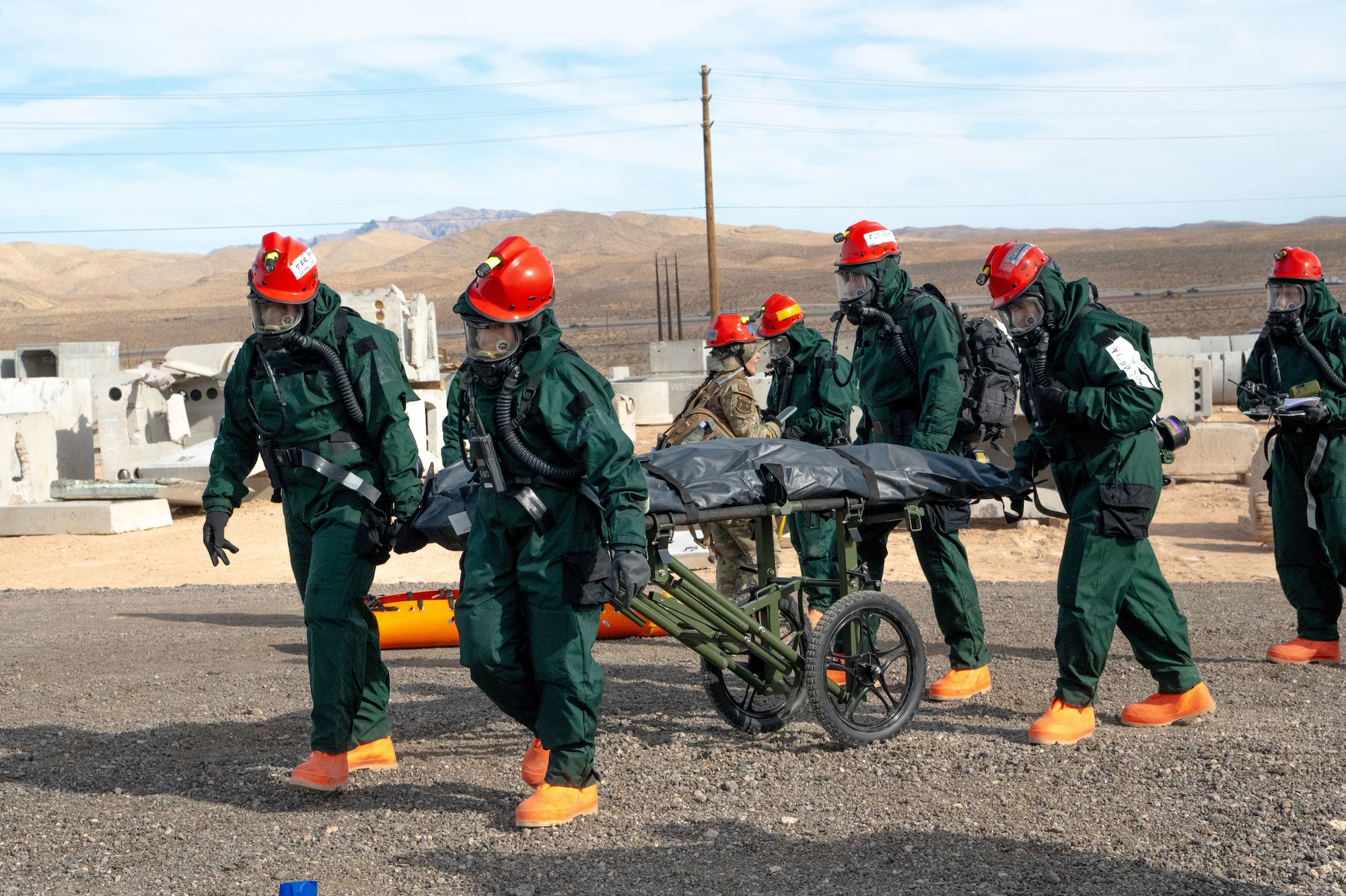 Members of the 162nd Wing Fatality Search and Recovery Team transport remains during the Nevada Chemical, Biological, Radiological, Nuclear Enhanced Response Force Package Sustainment Year Combined Training Event at Nellis Air Force Base, Mar. 1, 2025. Joint exercises, such as the Nevada CBRN CERFP SYCTE enable the 162nd FSRT to demonstrate and rehearse for complex, large-scale military operations. (U.S,. Air National Guard photo by Tech. Sgt. Van Whatcott)