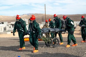 Members of the 162nd Wing Fatality Search and Recovery Team transport remains during the Nevada Chemical, Biological, Radiological, Nuclear Enhanced Response Force Package Sustainment Year Combined Training Event at Nellis Air Force Base, Mar. 1, 2025. Joint exercises, such as the Nevada CBRN CERFP SYCTE enable the 162nd FSRT to demonstrate and rehearse for complex, large-scale military operations. (U.S,. Air National Guard photo by Tech. Sgt. Van Whatcott)
