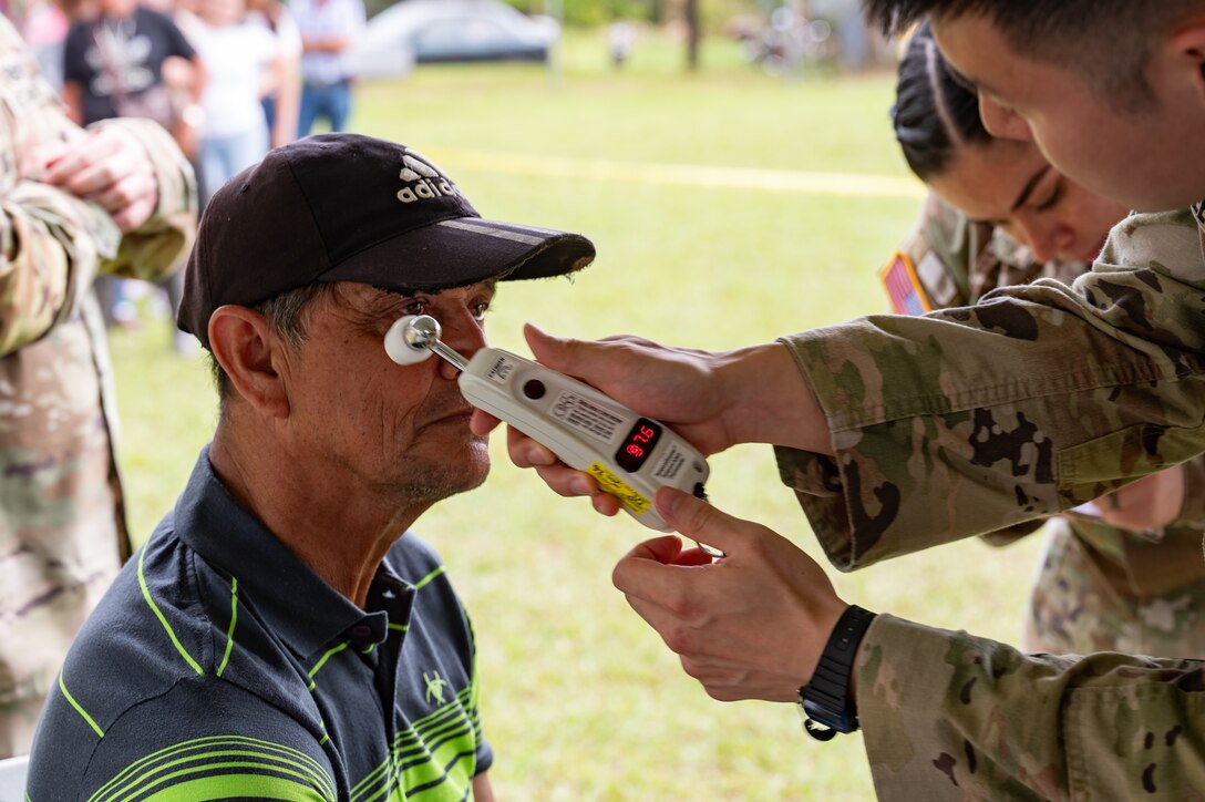 U.S. Army Spc. Jason Lee, Joint Task Force-Bravo 349th Medical Detachment medic, takes the temperature of a patient during a Medical Readiness Training Exercise in Pejibaye, Costa Rica, February 25, 2025.