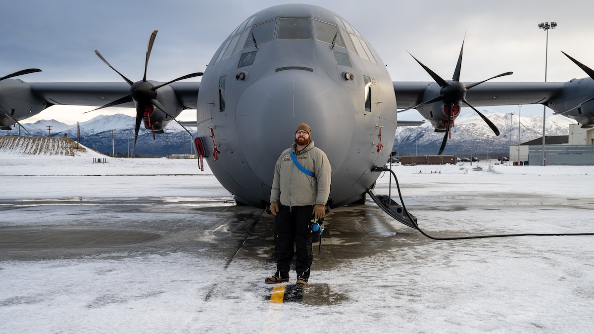 U.S. Air Force Tech. Sgt. Tyler Nelson, 317th Aircraft Maintenance Squadron flying crew chief and Lethal Expeditionary Airman Development course graduate, stands in front of a C-130J Super Hercules during Joint Pacific Multinational Readiness Center exercise 25-02 at Joint Base Elmendorf-Richardson, Alaska, Jan. 22, 2025. JPMRC 25-02 tested what Nelson learned from the LEAD program to succeed in operationally limited environments and allowed him to lead and train a maintenance team in extreme cold weather conditions. (U.S. Air Force photo by Airman 1st Class Jade M. Caldwell)