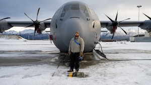 U.S. Air Force Tech. Sgt. Tyler Nelson, 317th Aircraft Maintenance Squadron flying crew chief and Lethal Expeditionary Airman Development course graduate, stands in front of a C-130J Super Hercules during Joint Pacific Multinational Readiness Center exercise 25-02 at Joint Base Elmendorf-Richardson, Alaska, Jan. 22, 2025. JPMRC 25-02 tested what Nelson learned from the LEAD program to succeed in operationally limited environments and allowed him to lead and train a maintenance team in extreme cold weather conditions. (U.S. Air Force photo by Airman 1st Class Jade M. Caldwell)
