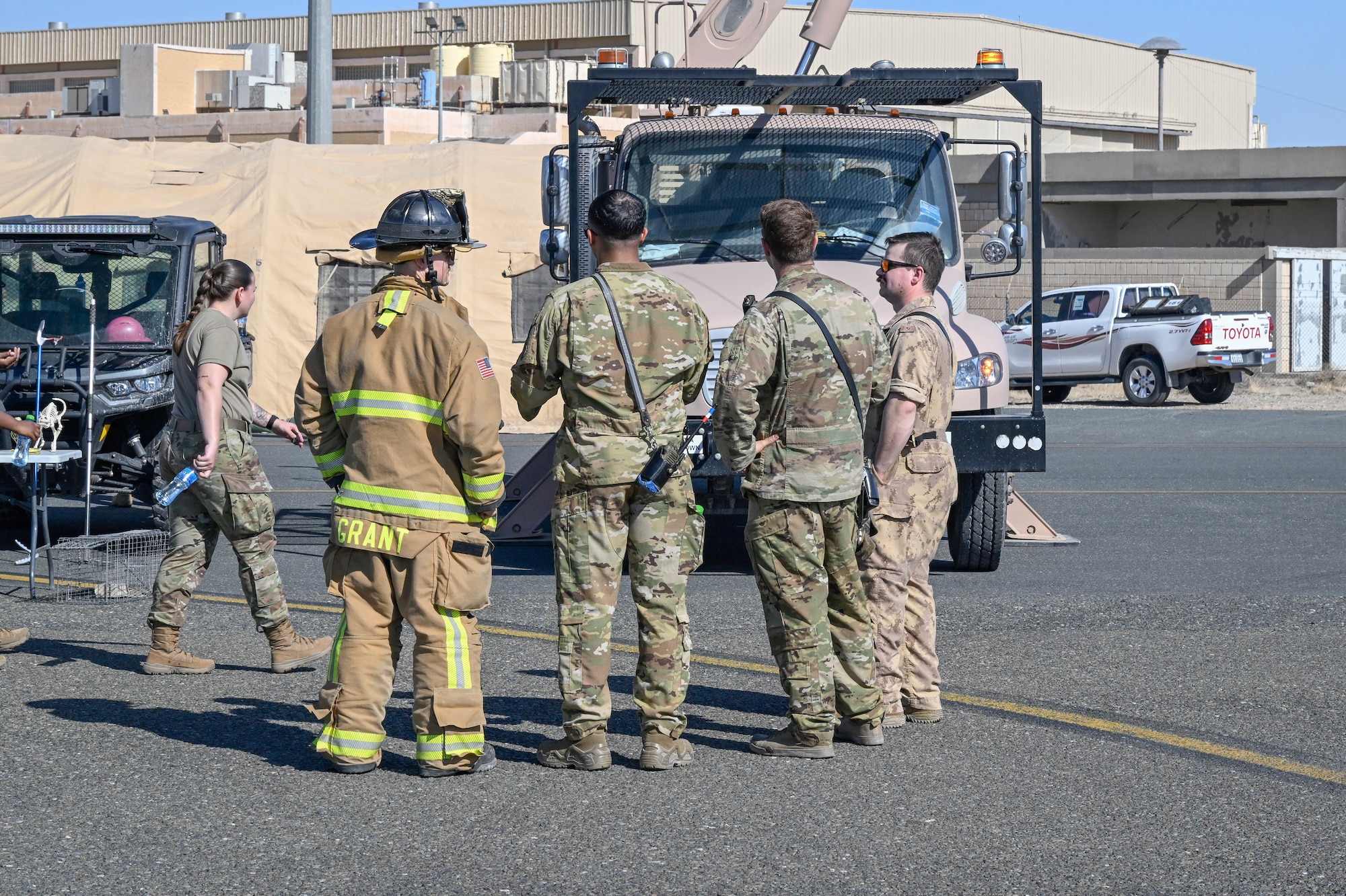 People in uniform conversate.