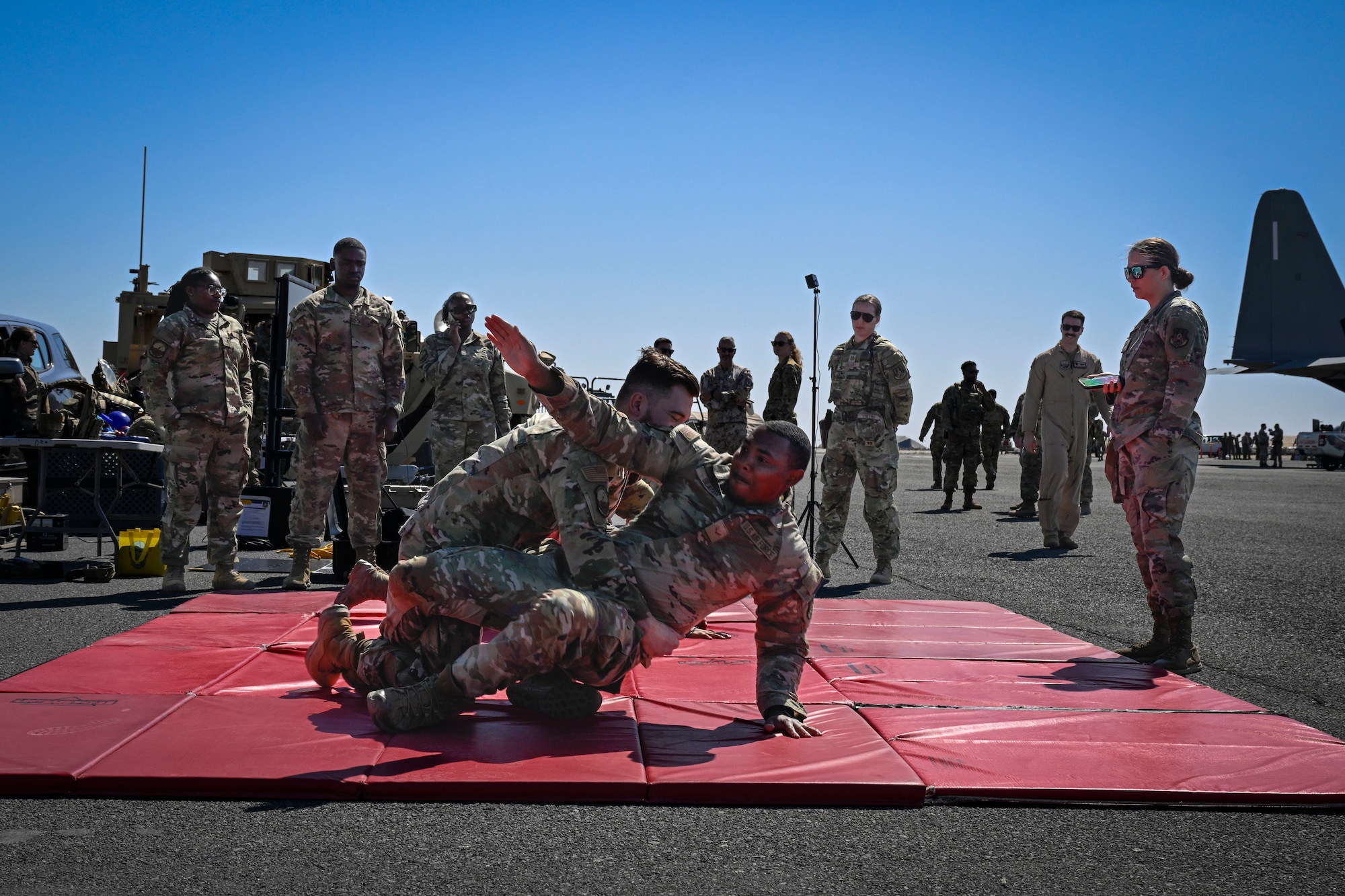 People in uniform practice self defense tactics.