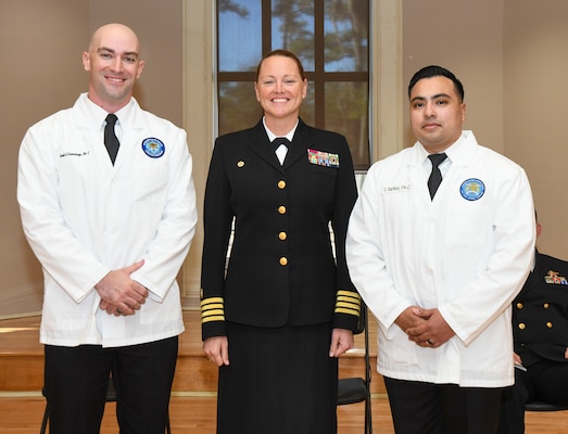 Capt. Anja Dabelić, center, director Naval Medical Center Camp Lejeune, poses for a photo with Lt. jg. Scott Cummings, left, and Lt. jg. Christian Martinez. Cummings had highest grade point average for the recent Interservice Physician Assistants Program class; Martinez was a close second only 0.24 points behind Cummings.