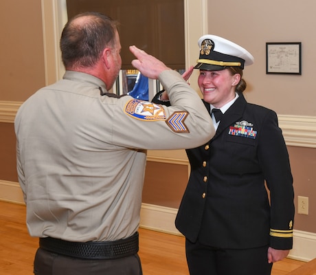 Lt. jg. Kaylee Sheppeck renders her first salute as a Naval Officer to her father during the NMCCL Interservice Physician Assistants Program (IPAP) graduation and commissioning ceremony at Marston Pavilion on Marine Corps Base Camp Lejeune on Feb.28, 2025.