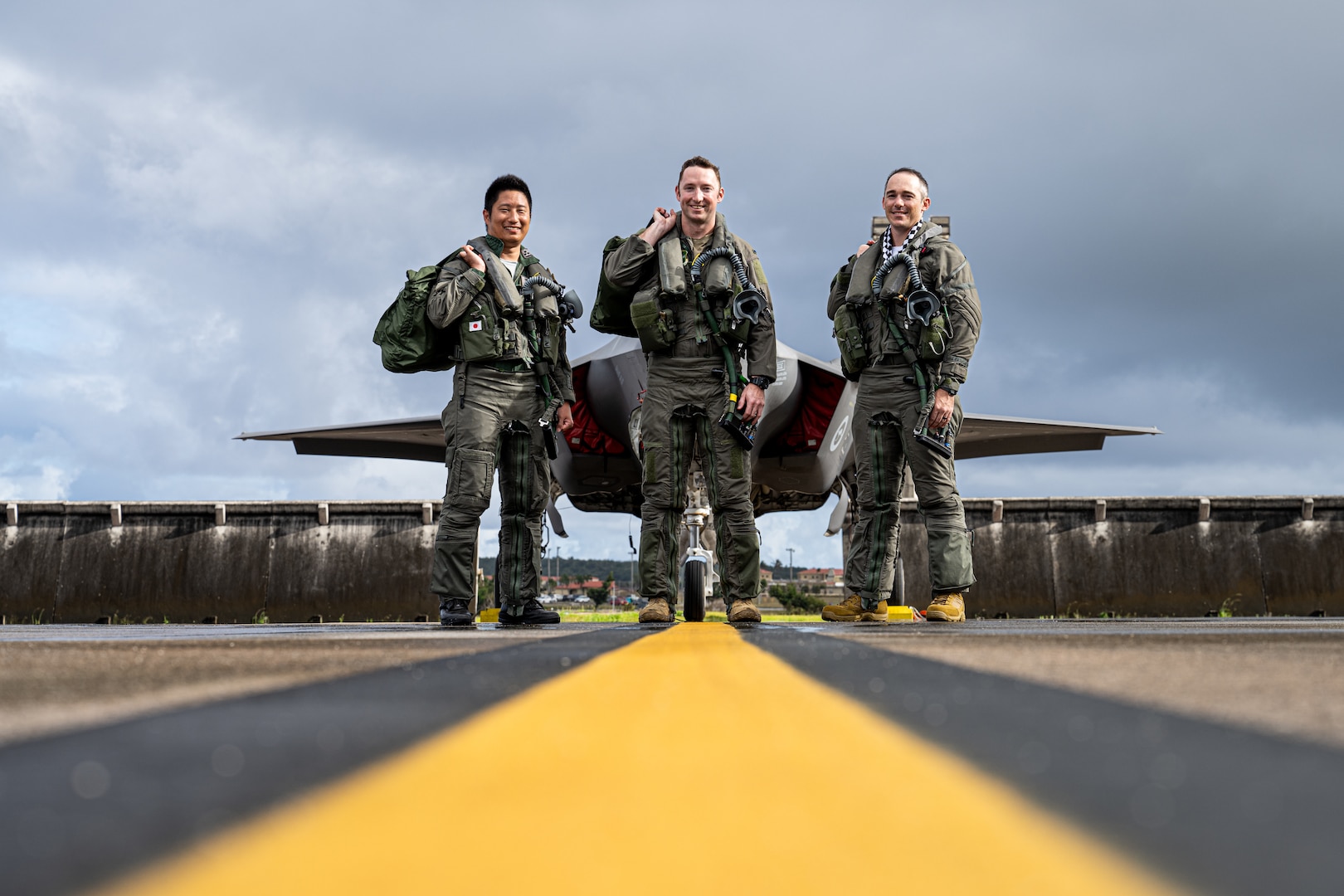 From left: Japan Air Self Defense Force Capt. Nakanishi, U.S. Air Force  Lt. Mike Watson and Royal Australian Air Force FLTLT Ryan in front of an F-35A Lightning II on the flightline for exercise Cope North 2025 at Andersen Air Force Base, Guam, Feb. 19, 2025. The multinational, U.S. Pacific Air Forces-sponsored field training exercise focused on conducting Combat Air Force training to increase interoperability.