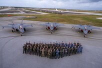 Allies from the United States, Japan and Australia come together on the flightline in front of three F-35A Lightning IIs to celebrate the end of exercise Cope North 2025 at Andersen Air Force Base, Guam, Feb. 21, 2025.