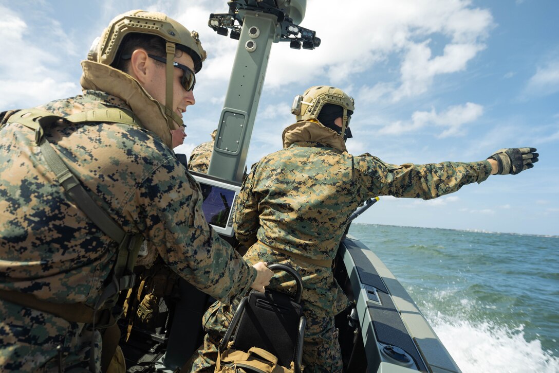 U.S. Marine Corps Cpl. Luke Barlow (left), assault amphibious vehicle crewman, and Lance Cpl. Dante Johnson, assault amphibious vehicle technician, 4th Assault Amphibian Battalion, 4th Marine Division, Marine Forces Reserve, spot simulated personnel for retrieval operations on a multi-mission reconnaissance craft–alpha variant, Tampa, Florida, March 4, 2025. The MMRC-A will enable Marines with 4th AABn to continue to train and operate in the maritime domain, supporting service level littoral maneuver concept development efforts. (U.S. Marine Corps photo by Lance Cpl. Van Hoang)