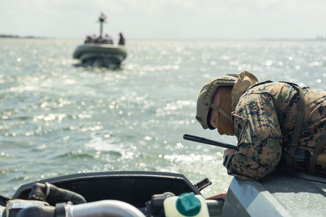 U.S. Marines Corps Gunnery Sgt. Jared Lingle, assault amphibious vehicle patrol leader, 4th Assault Amphibian Battalion, 4th Marine Division, Marine Forces Reserve, inspects an engine on a multi-mission reconnaissance craft–alpha variant–after conducting high-speed, open water maneuvers, Tampa, Florida, March 4, 2025. The MMRC-A will enable Marines with 4th AABn to continue to train and operate in the maritime domain, supporting service level littoral maneuver concept development efforts. (U.S. Marine Corps photo by Lance Cpl. Van Hoang)
