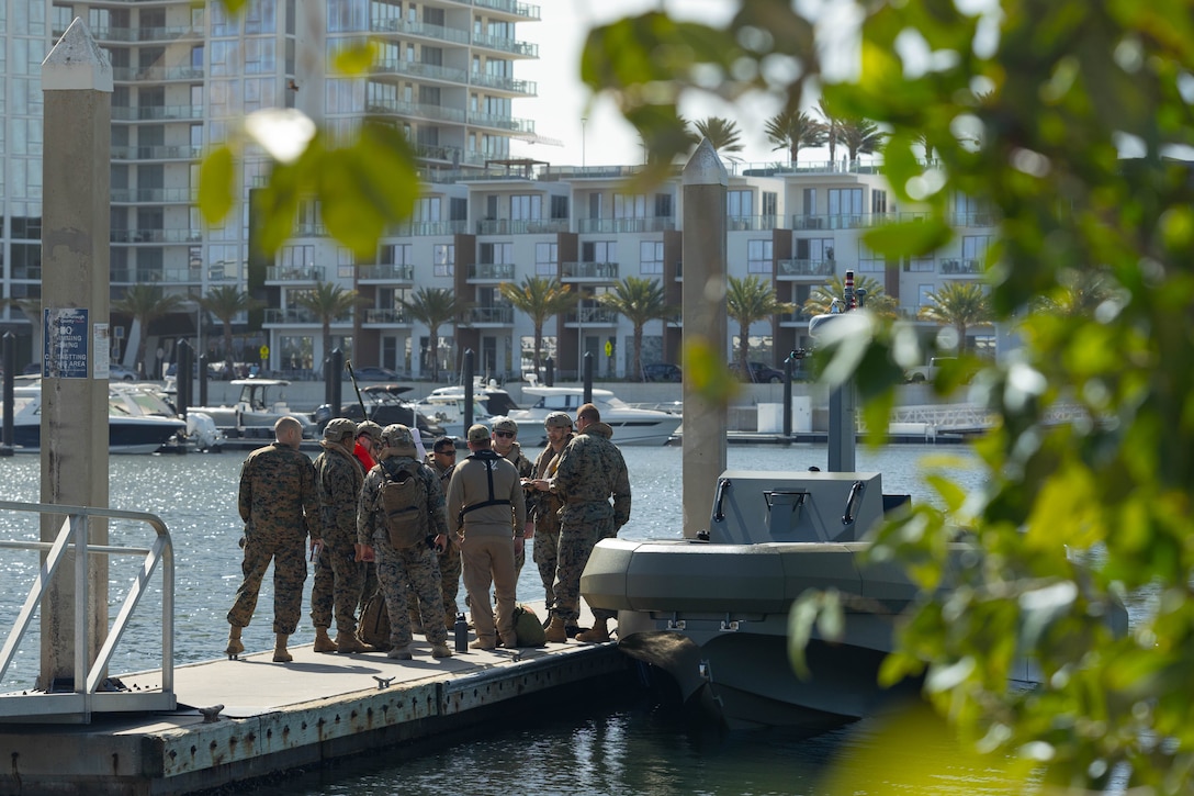U.S. Marines with 4th Assault Amphibian Battalion, 4th Marine Division, Marine Forces Reserve, have a brief before boarding a multi-mission reconnaissance craft–alpha variant, Tampa, Florida, March 4, 2025. The MMRC-A will enable Marines with 4th AABn to continue to train and operate in the maritime domain, supporting service level littoral maneuver concept development efforts. (U.S. Marine Corps photo by Lance Cpl. Van Hoang)