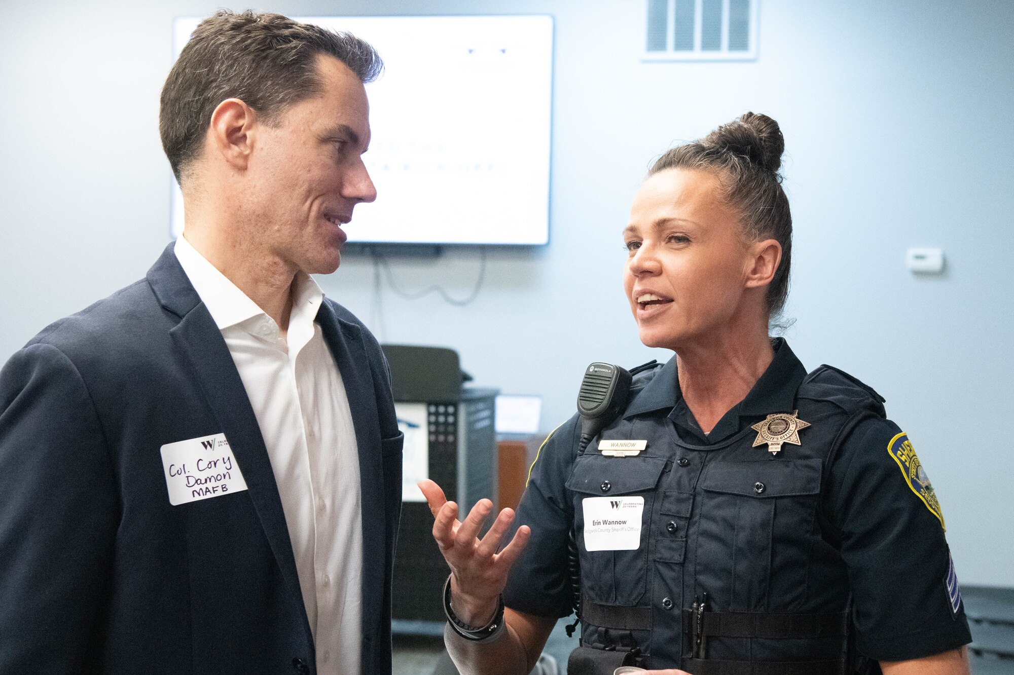 Col. Cory Damon, 22nd Air Refueling Wing commander, talks with police Sgt. Erin Wannow, Sedgwick County Sheriff Department police officer, at the Kansas Aviation Museum in Wichita, Kansas, March 4, 2025. Wannow was is part of the 2025 Mission Wichita class, which builds rapport with McConnell Airmen and the surrounding community. (U.S. Air Force photo by Airman 1st Class Patrick O'Neill)