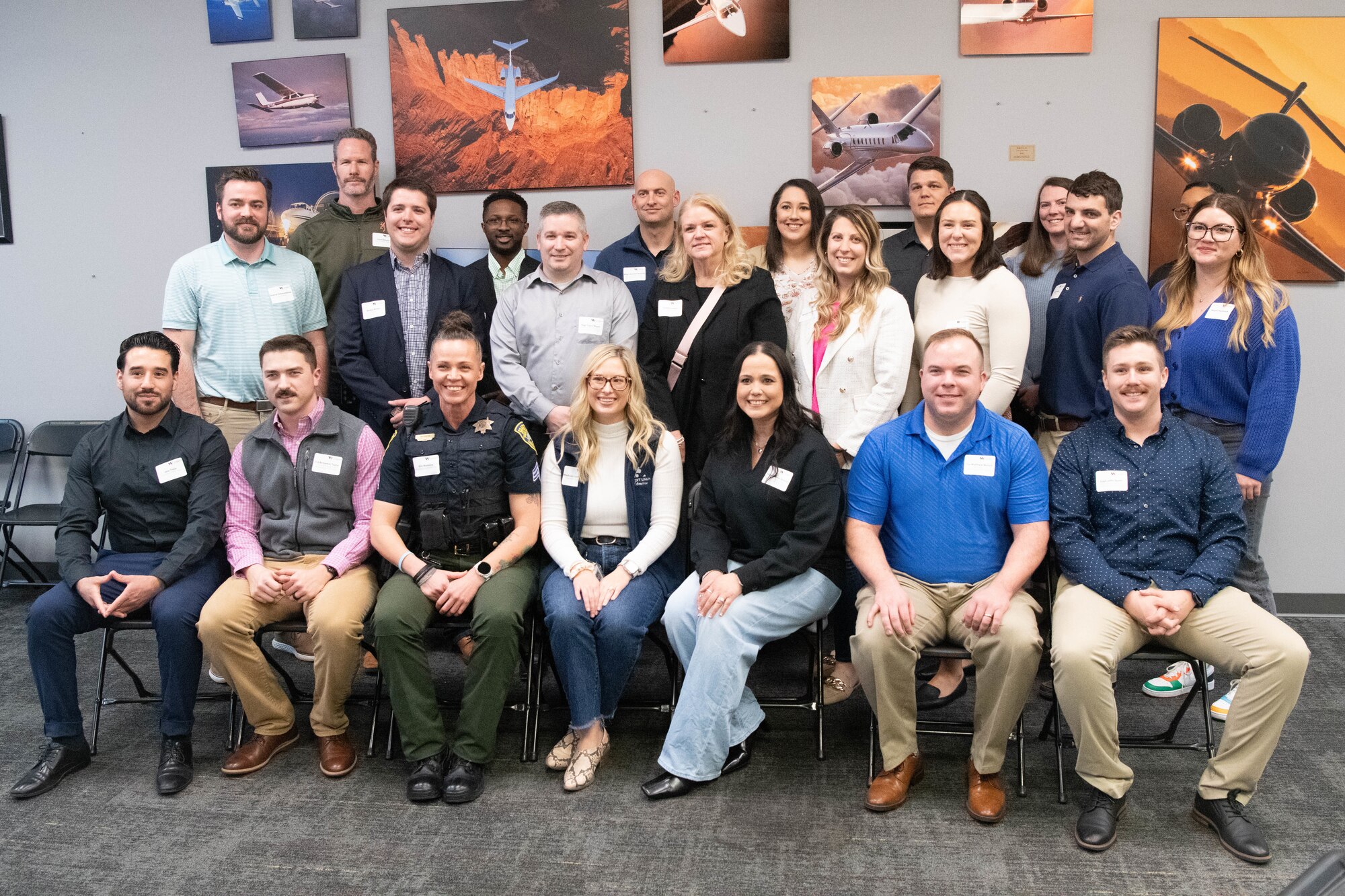 The 2025 Mission Wichita class poses for a photo at the kick-off event at the Kansas Aviation Museum in Wichita, Kansas, March 4, 2025. Mission Wichita is a program that connects McConnell Airmen and Wichita locals to reinforce the relationship between the military and young professionals within the community. (U.S. Air Force photo by Airman 1st Class Patrick O'Neill)