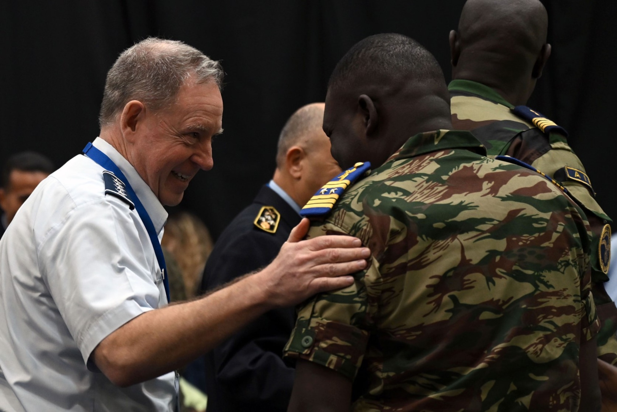U.S. Air Force Gen. James Hecker, U.S. Air Forces in Europe - Air Forces Africa commander speaks with Brig. Gen. Alexis Nguema, chief of staff of the Gabon air force, during the 14th African Air Chiefs Symposium in Lusaka, Zambia, Feb. 18, 2025. Key personnel gathered to review and practice their response to a simulated natural disaster emergency. (U.S. Air Force photo by Seleena Muhammad-Ali)