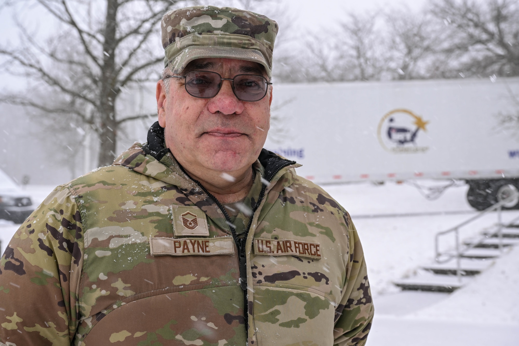 Master Sgt. Dale Payne, NCOIC of civil engineering and force support with the Department of Defense’s Innovative Readiness Program Combined Asset Management Site, poses for a photo in front of one of the IRT trailers that he’s hauled for thousands of miles, March 2, 2025.