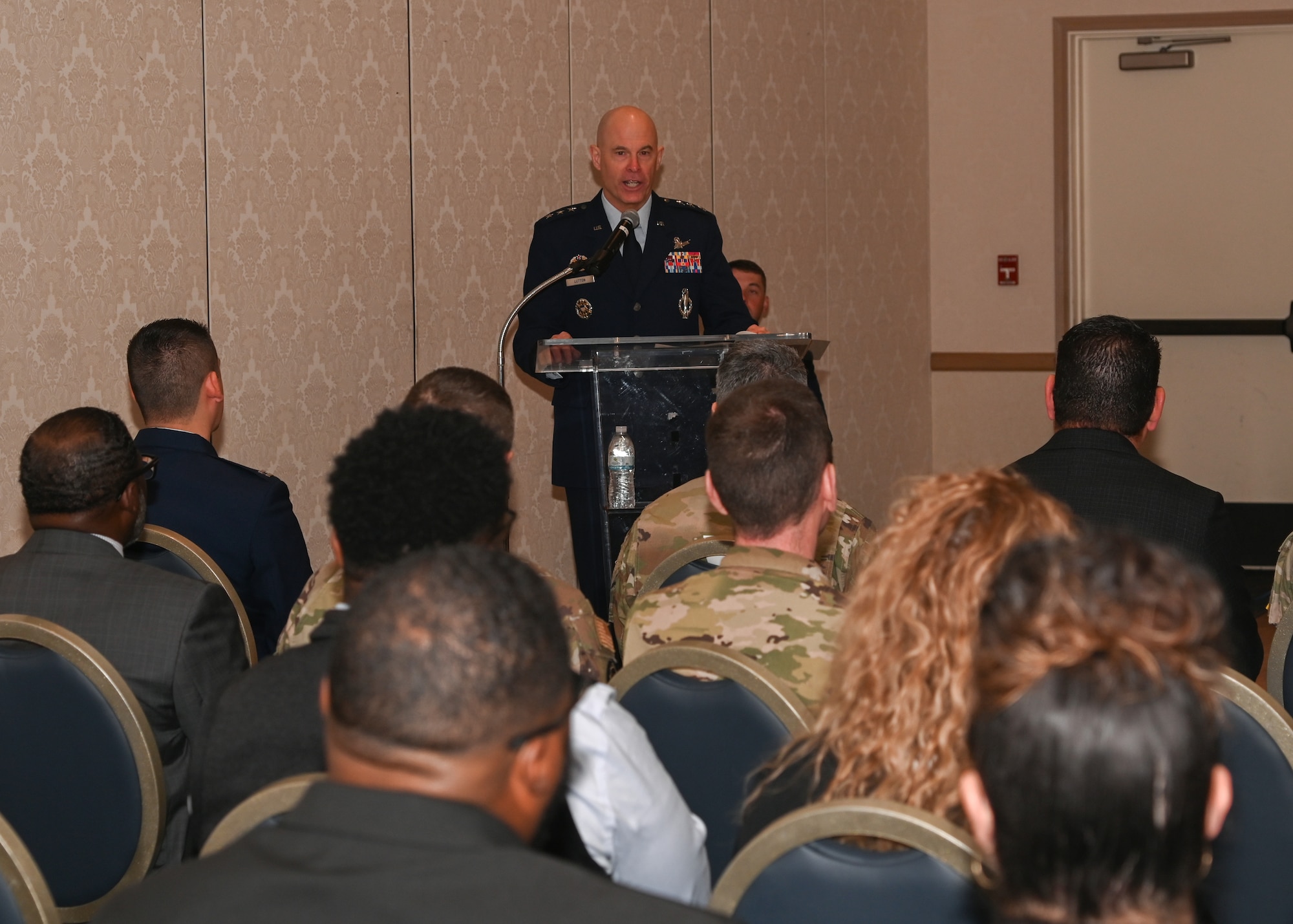 military members gathered in a room to activate the detachment 9 with SATAF, audience is in OCPs and the speakers are in blues