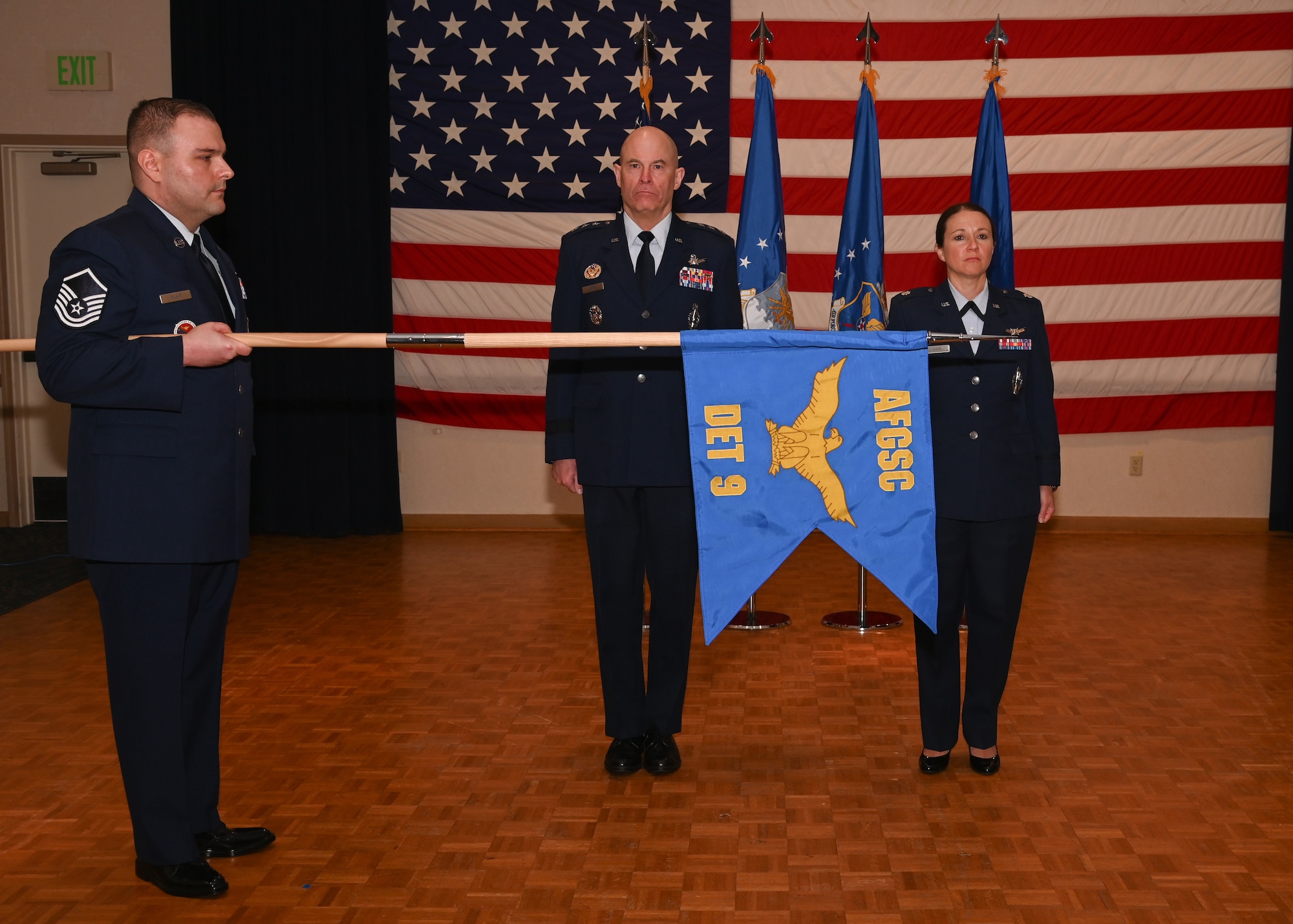 military members gathered in a room to activate the detachment 9 with SATAF, audience is in OCPs and the speakers are in blues