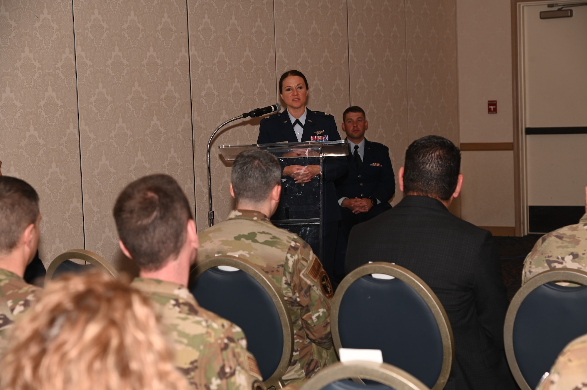 military members gathered in a room to activate the detachment 9 with SATAF, audience is in OCPs and the speakers are in blues