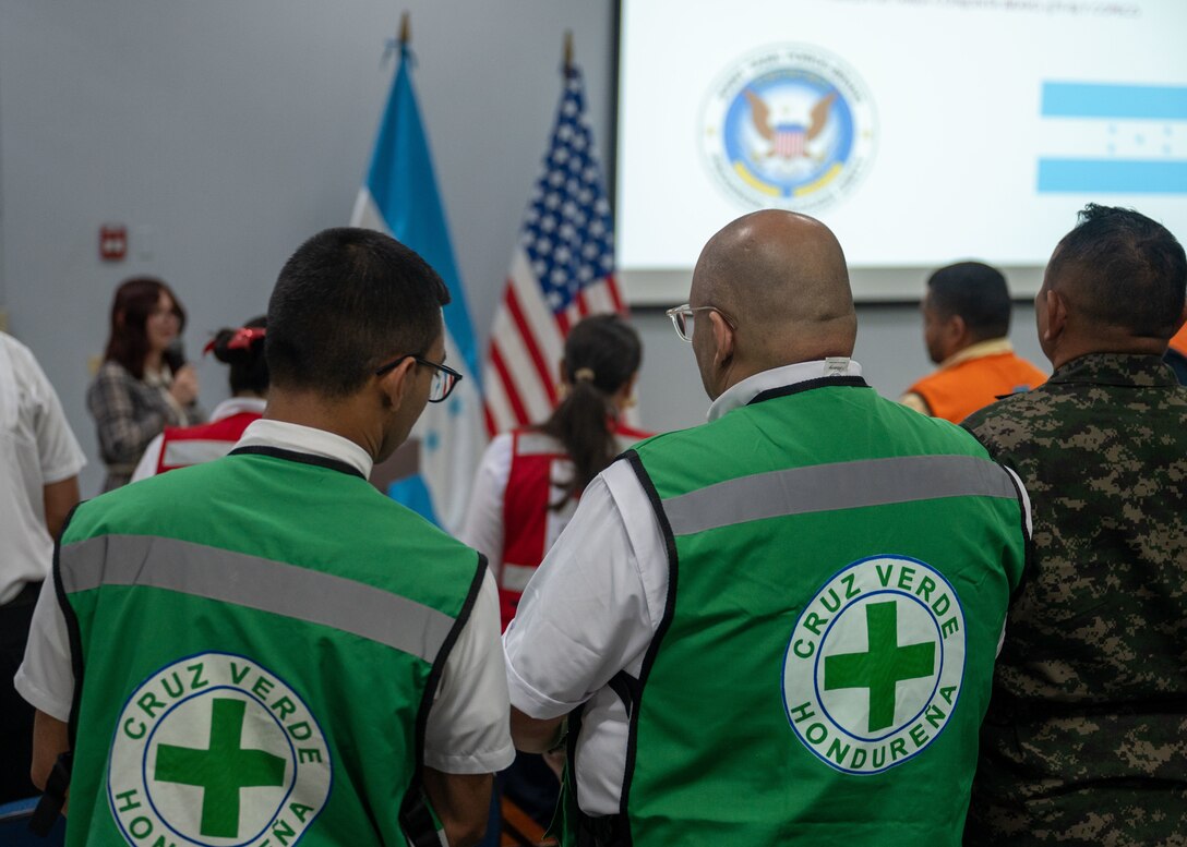 Two members from Honduran Green Cross stand for opening remarks during Jaguar Sentinel, a JTF-Bravo led tabletop exercise Feb. 28, 2025, Tegucigalpa, Honduras. Jaguar Sentinel is a forum for key players to share experience, capabilities and act as force multipliers during a crisis. (U.S. Air Force photo)