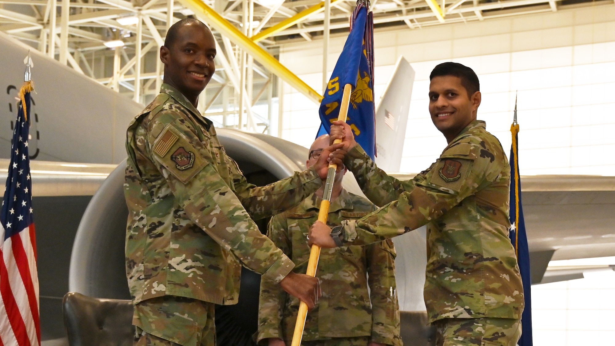 (Left to right) Col. Jermaine Campbell, 931st Maintenance Group commander, hands the guidon to Maj. Uddit Patel, incoming 931st Aircraft Maintenance Commander.