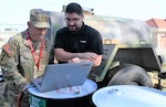 Dr. Robert Gaeta, Chief of Nephrology at Womack Army Medical Center (L) reads over data as a mock dialysis takes place on the Womack campus