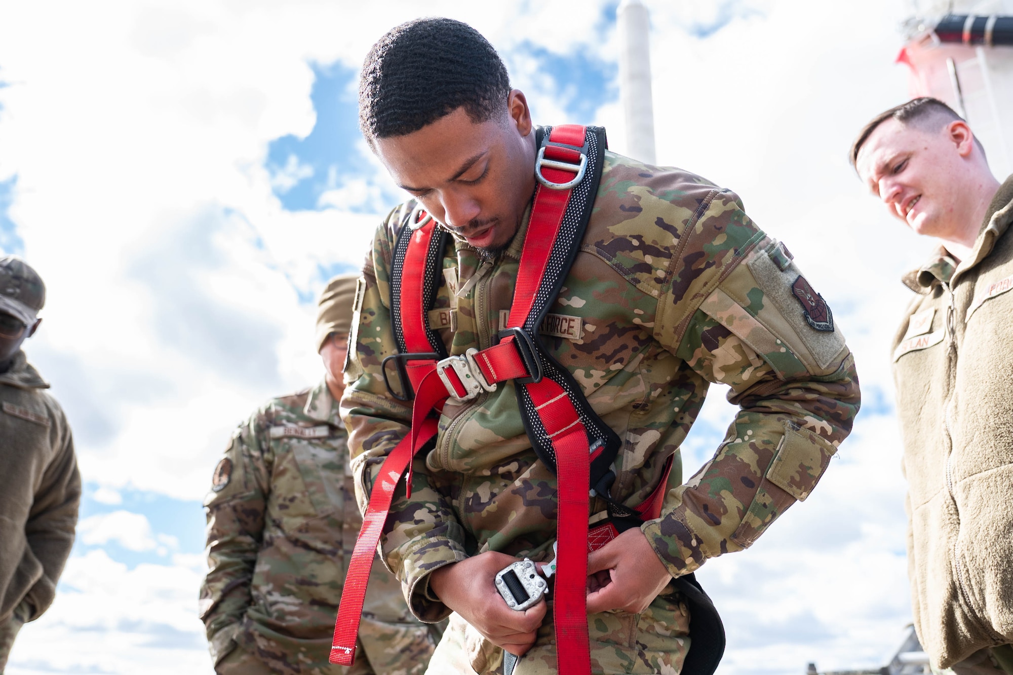 Man in uniform performs missile maintenance.