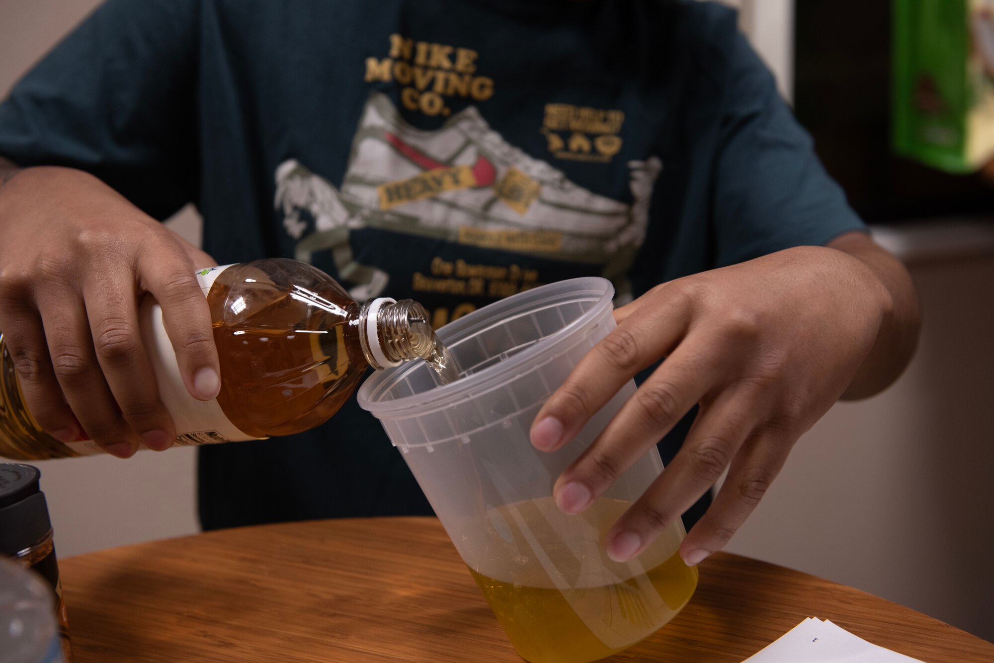 A U.S. Air Force customer service technician assigned to the 1st Special Operations Wing mixes vinegar and olive oil at Hurlburt Field, Florida, Feb. 11, 2025.