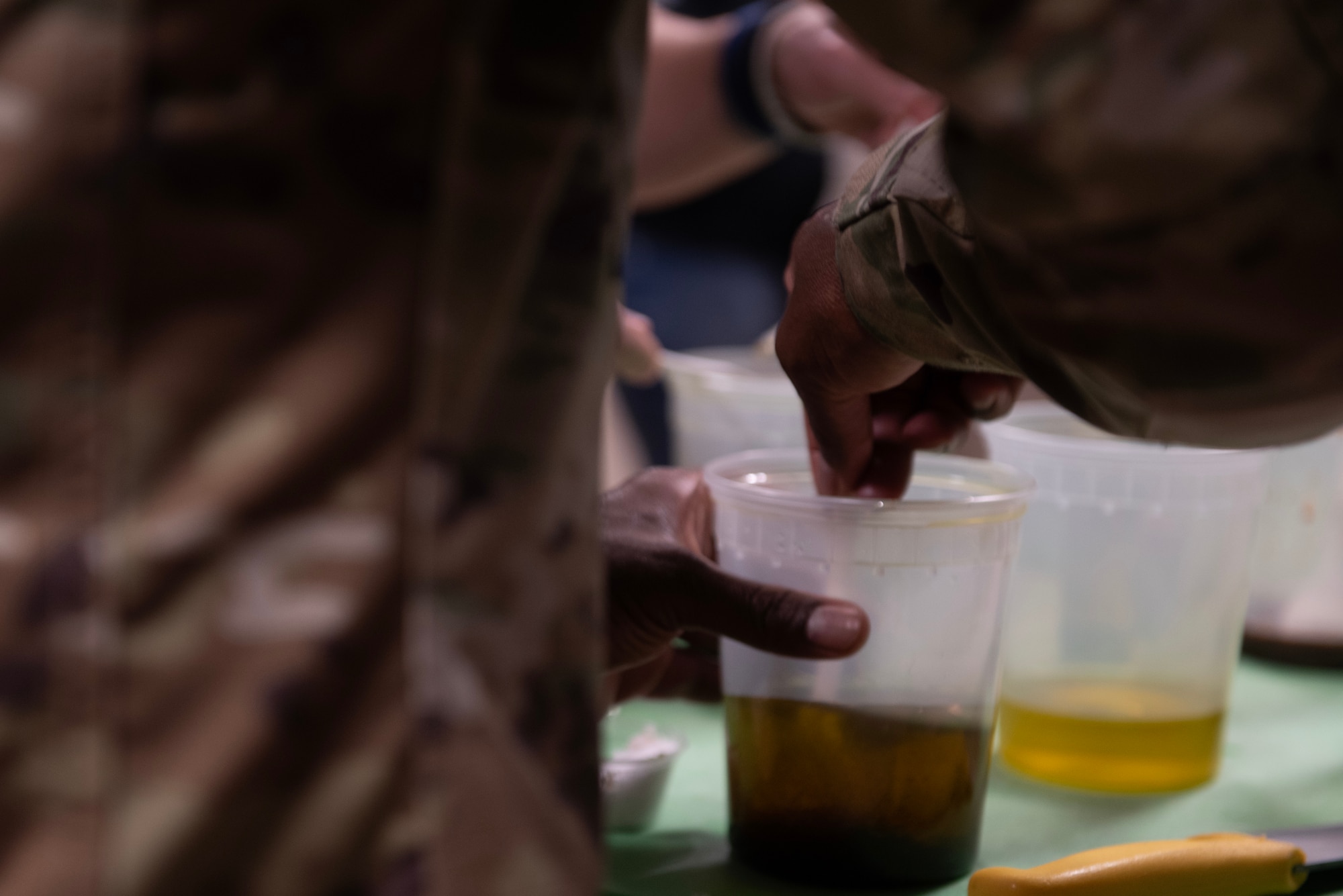 U.S. Air Force Chief Master Sgt. Ralph Oliver, 1st Special Operations Wing command chief, stirs ingredients for salad dressing at Hurlburt Field, Florida, Feb. 11, 2025.