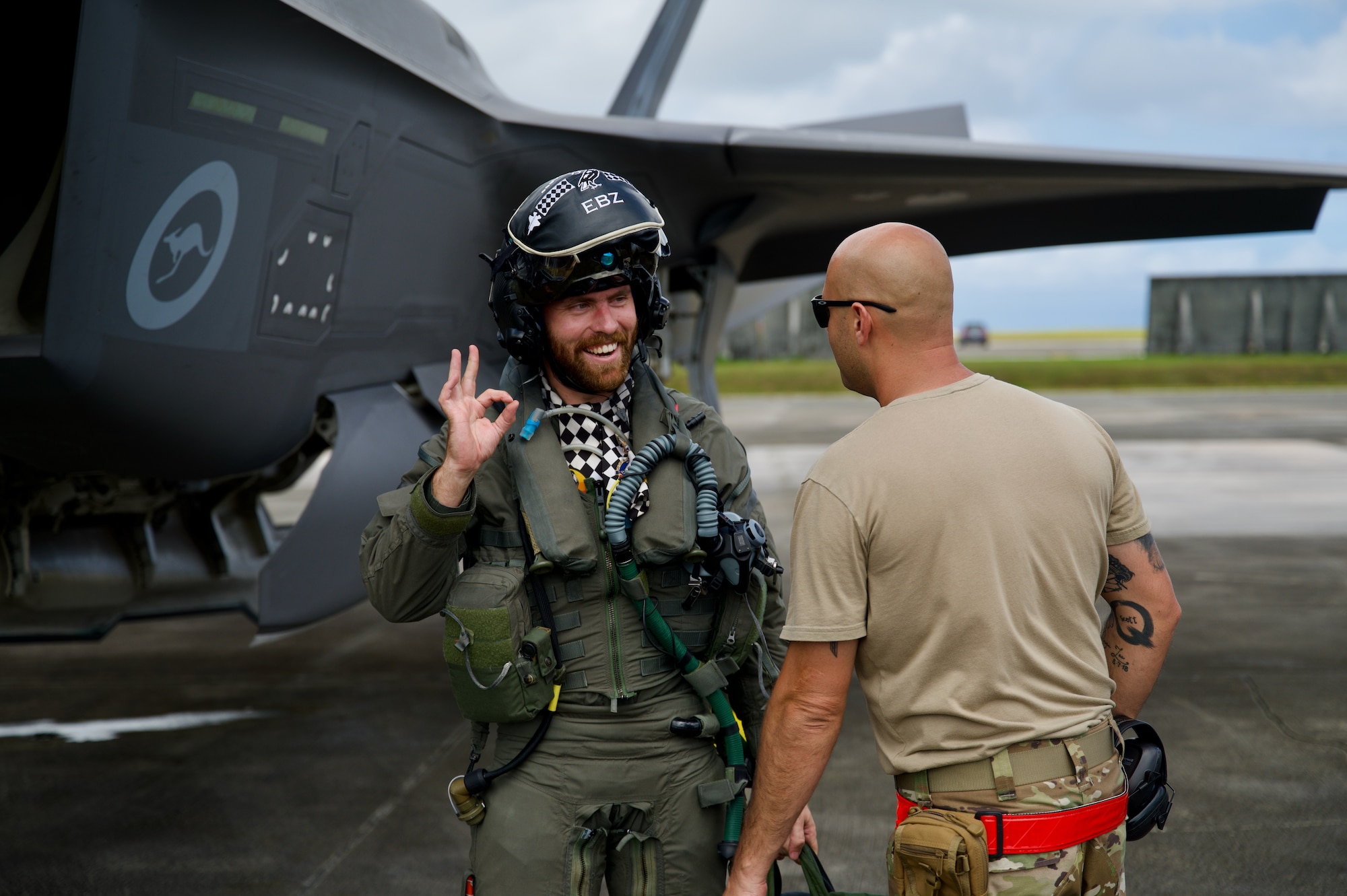 Photo of Royal Australian Air Force Flight Lieutenant Nicholas Ebzery, 75 Squadron, giving the post flight "OK" to U.S. Air Force Staff Sgt. Cale Roberge, a crew chief from the 158th Fighter Wing, during Cope North 2025, Feb. 9, 2025.