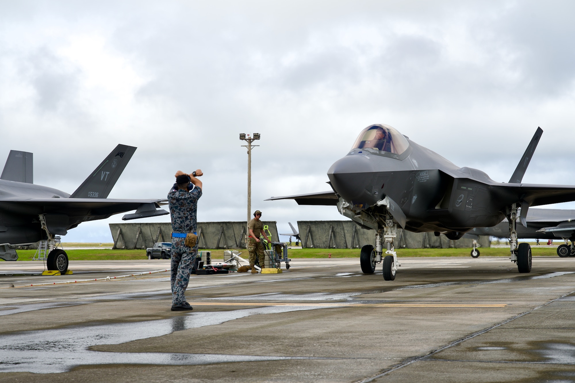 Photo of Japan Air Self-Defense Force Tech. Sgt. Shoi Semba recovering a U.S. Air Force F-35A Lightning II from the 158th Fighter Wing during Cope North 2025, Feb. 9, 2025. As part of cross-service integration, Japanese crew chiefs worked between flight rotations, honing communication with pilots and providing post-flight marshaling services. This collaboration underscores the exercise’s emphasis on interoperability and Agile Combat Employment.
