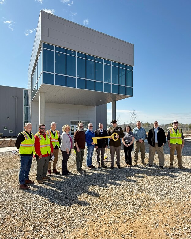 Lt. Col. Robert W. Green, U.S. Army Corps of Engineers Nashville District commander, presents a symbolic key to the new K-25 Interpretive Center to Jay Mullis, U.S. Department of Energy’s Oak Ridge Office of Environmental Management manager, during a turnover of the facility March 4, 2025, at East Technology Park in Oak Ridge, Tennessee.