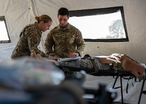 Service members stage patients for an evacuation flight during an exercise