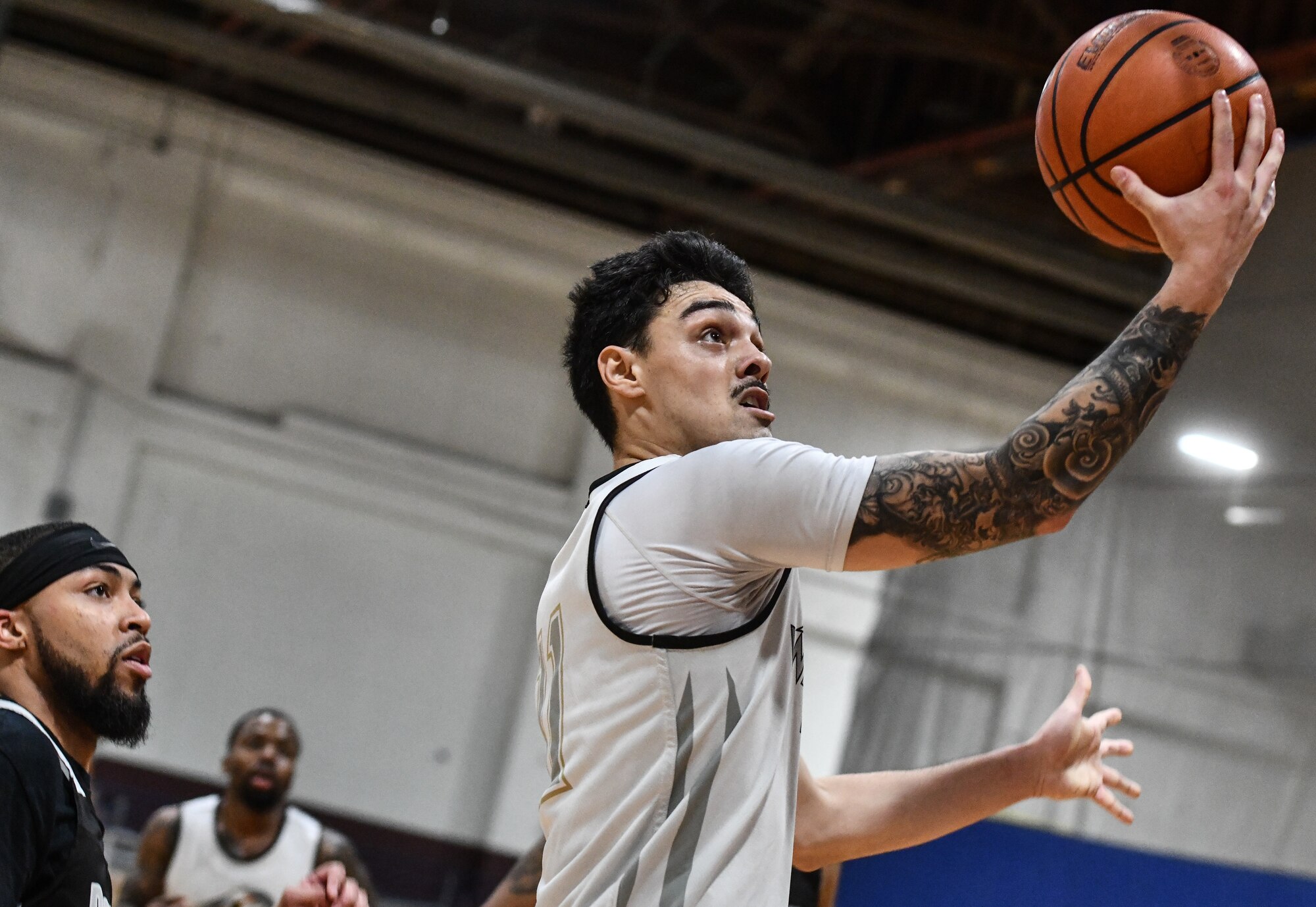 Airman 1st Class Enteria Pickering, 338th Combat Training Squadron, drives for a lay-up during Offutt's overtime win against Peterson Space Force Base on Feb. 1, 2025 at the Offutt Air Force Base Field House. (U.S. Air Force photo by Chad Watkins)
