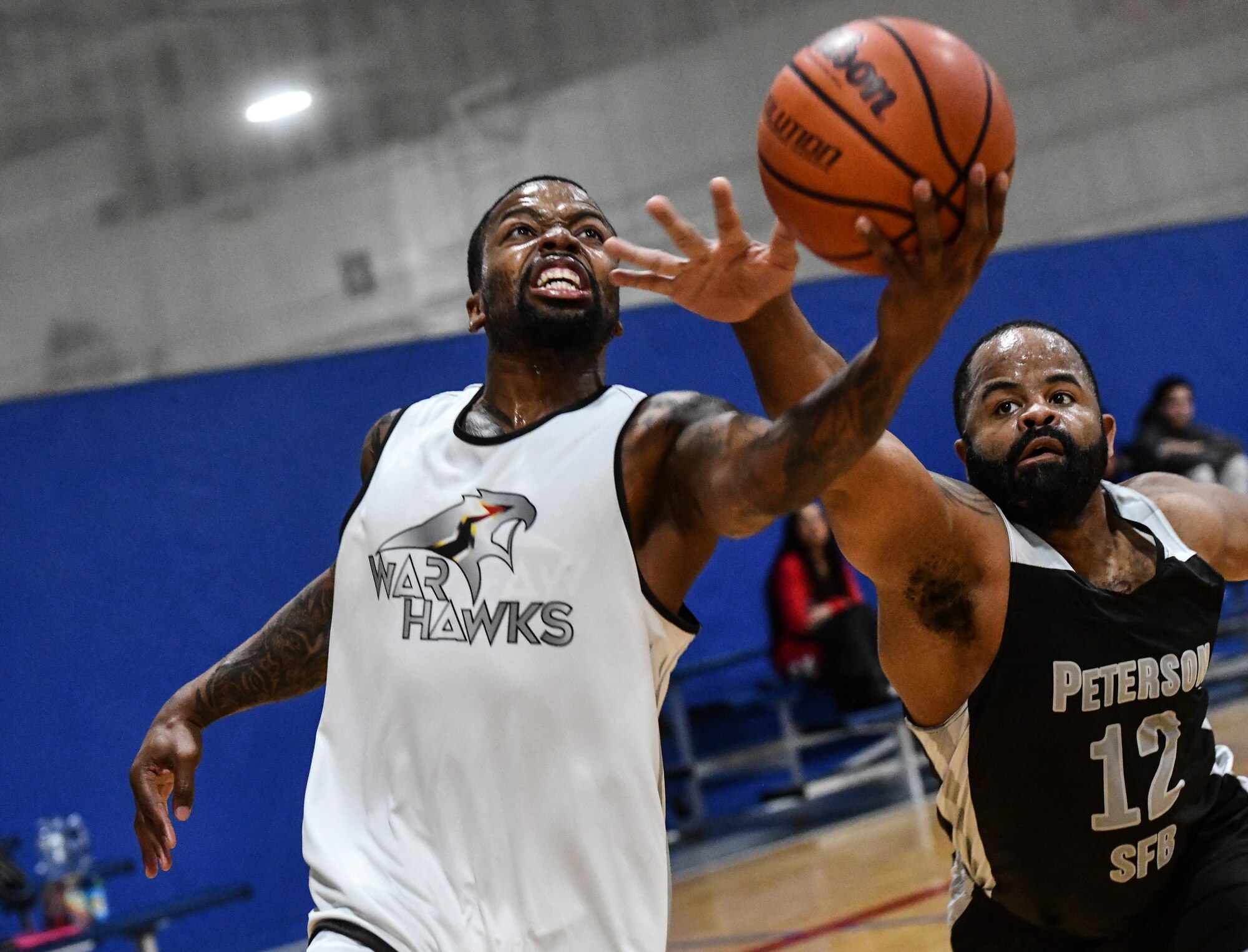 Offutt's Mike Scott goes for a lay-up around a Peterson Space Force defender during a game at the Offutt Air Force Base Field House on Feb. 1, 2025. Scott is a dependant playing on the team. (U.S. Air Force photo by Chad Watkins)