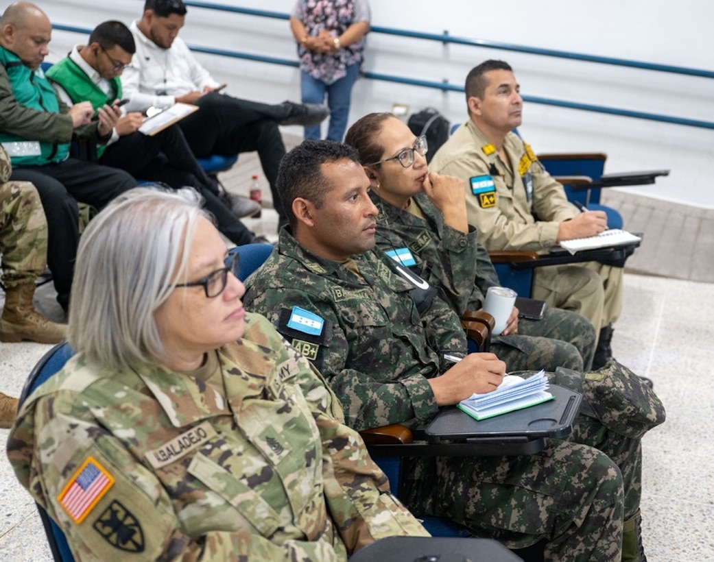 U.S. Army Sgt. Maj. Aritza Albaladejo, alongside members of the Honduran military and Bomberos, listens to a scenario briefing during Jaguar Sentinel, a JTF-Bravo led tabletop exercise Feb. 28, 2025, Tegucigalpa, Honduras. Jaguar Sentinel is a forum for key players to share experience, capabilities and act as force multipliers during a crisis. (U.S. Air Force photo)