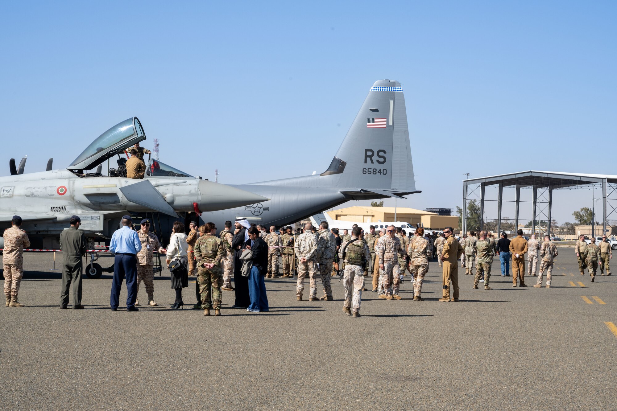 People in and out of uniform explore an air expo.