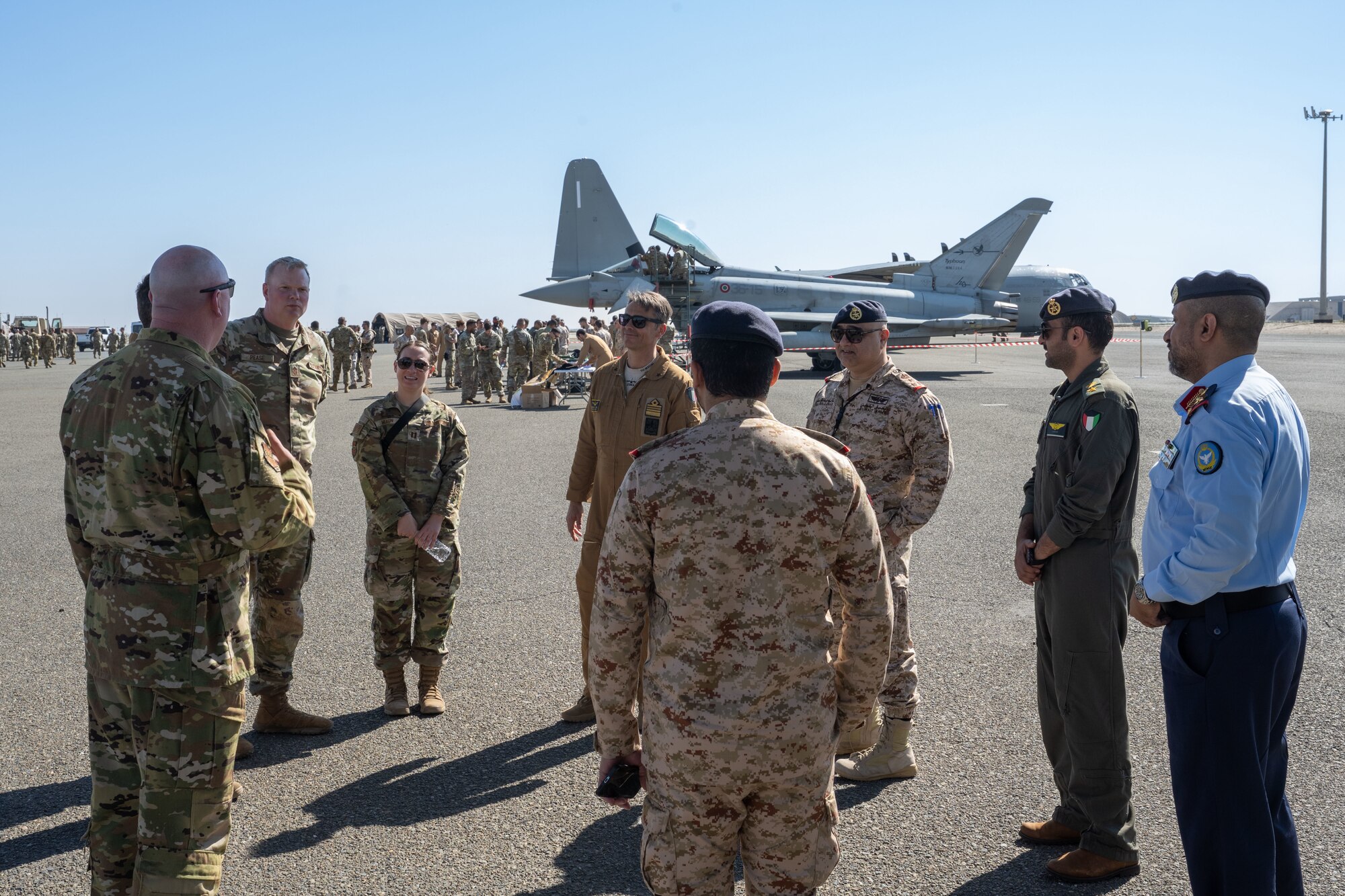 U.S., Italian, and host nation leaders speak to eachother during an air expo.